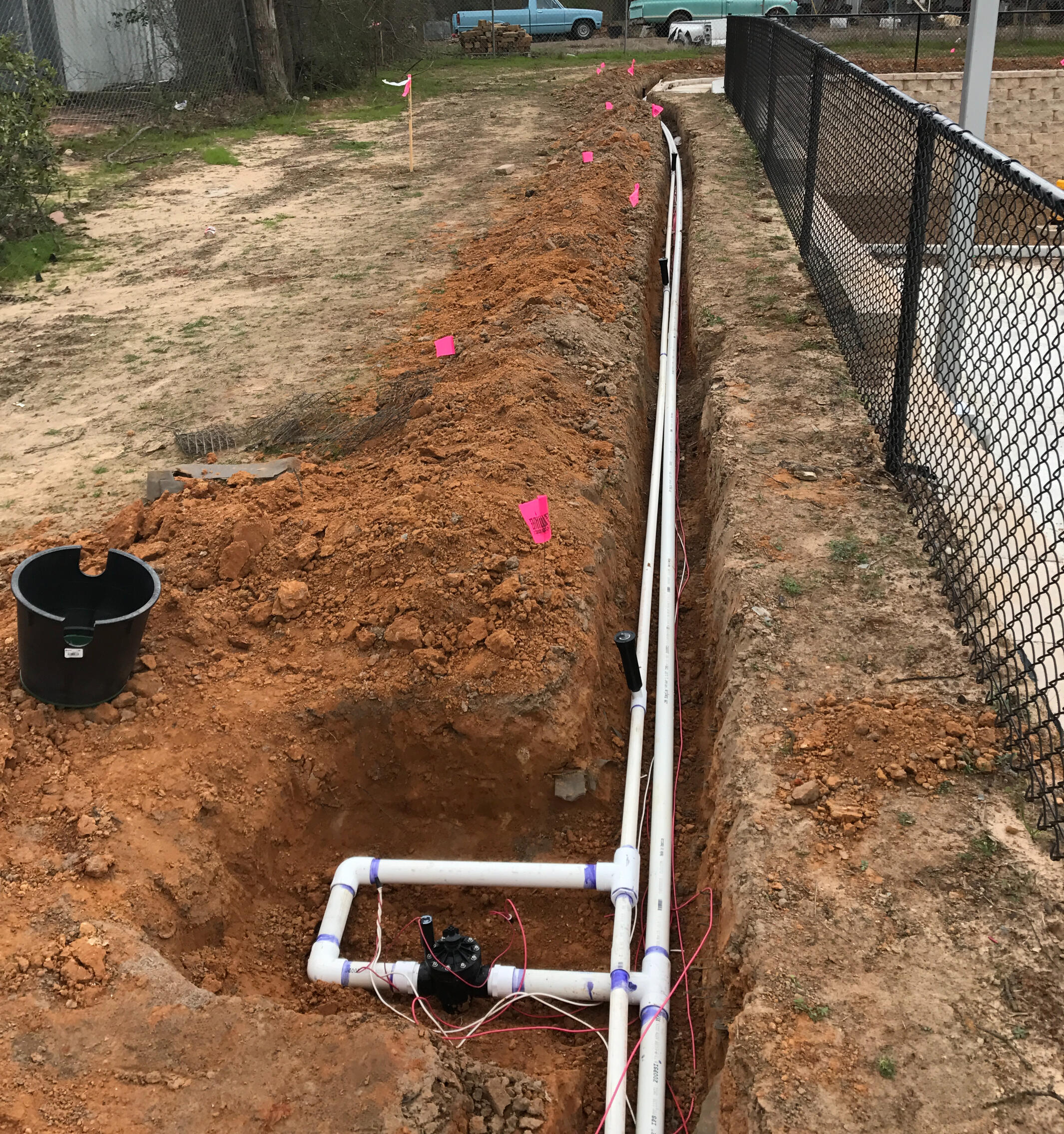 PVC irrigation piping installed in trench in Tyler, Texas. Durable underground sprinkler system setup for reliable East Texas irrigation performance.