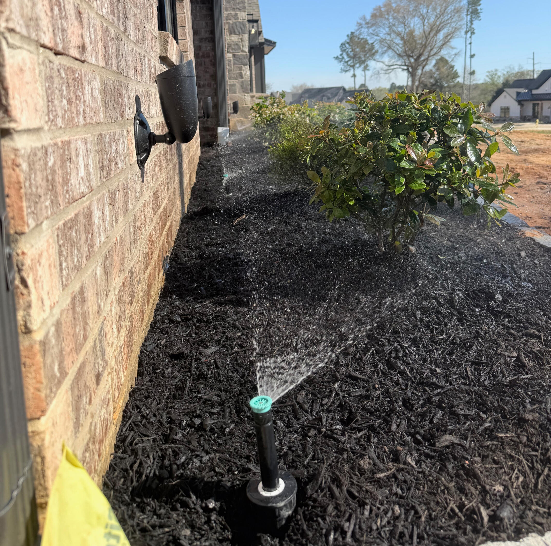 Hans de Jong Irrigation Company Commercial multi-line PVC irrigation trench installation in Longview, Texas. Advanced irrigation system construction for large East Texas properties.