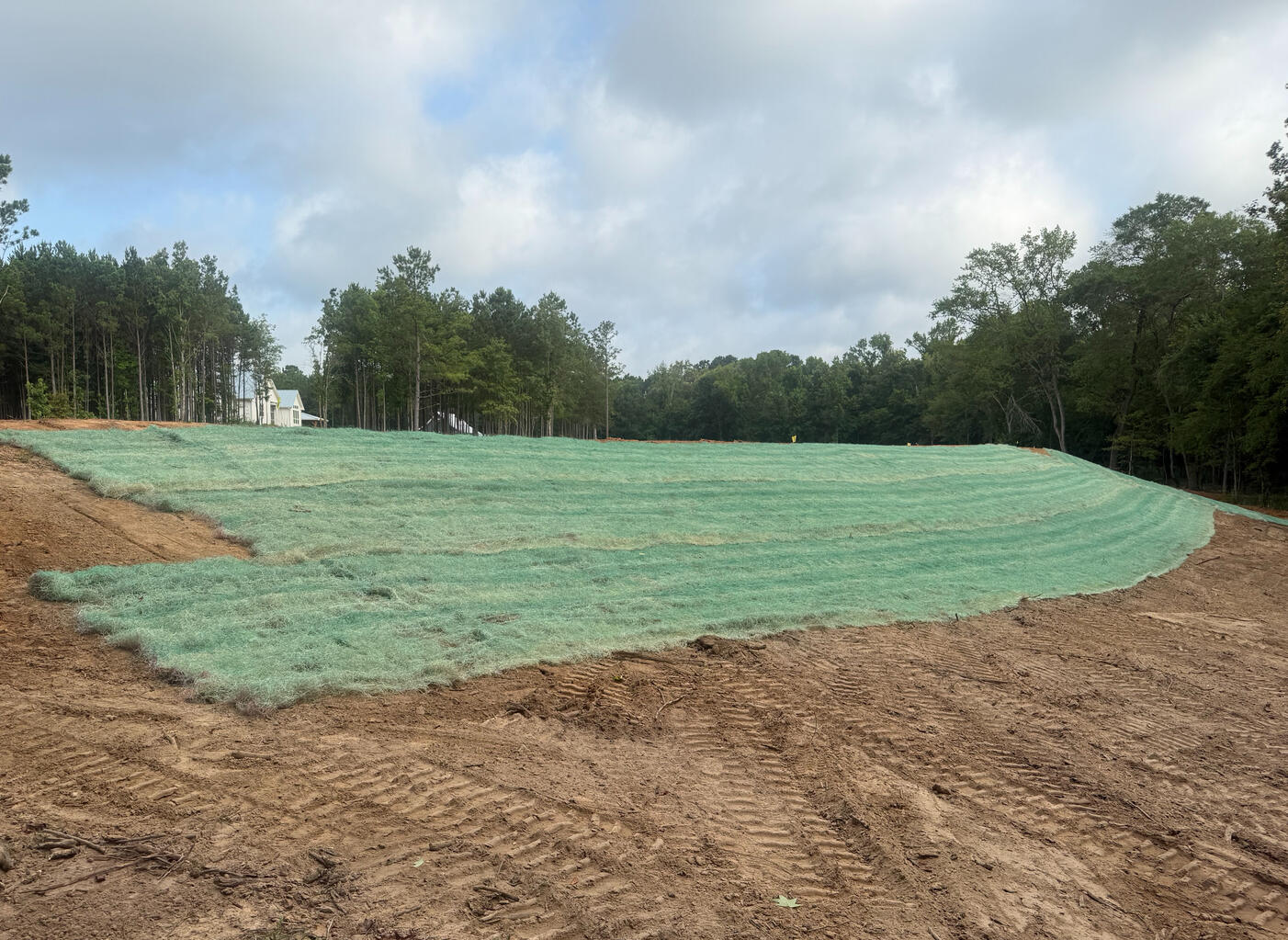 Fresh sod installation project on a hillside in Tyler, Texas. Complete irrigation and lawn preparation services for strong turf growth in East Texas.