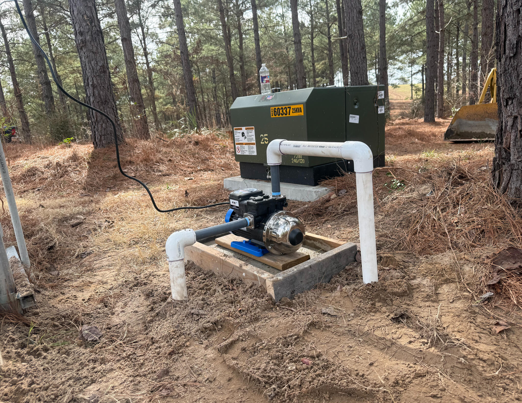 Above-ground water pump system installed near neighborhood utilities in Gladewater, Texas. Professional irrigation and pump solutions built for East Texas properties.