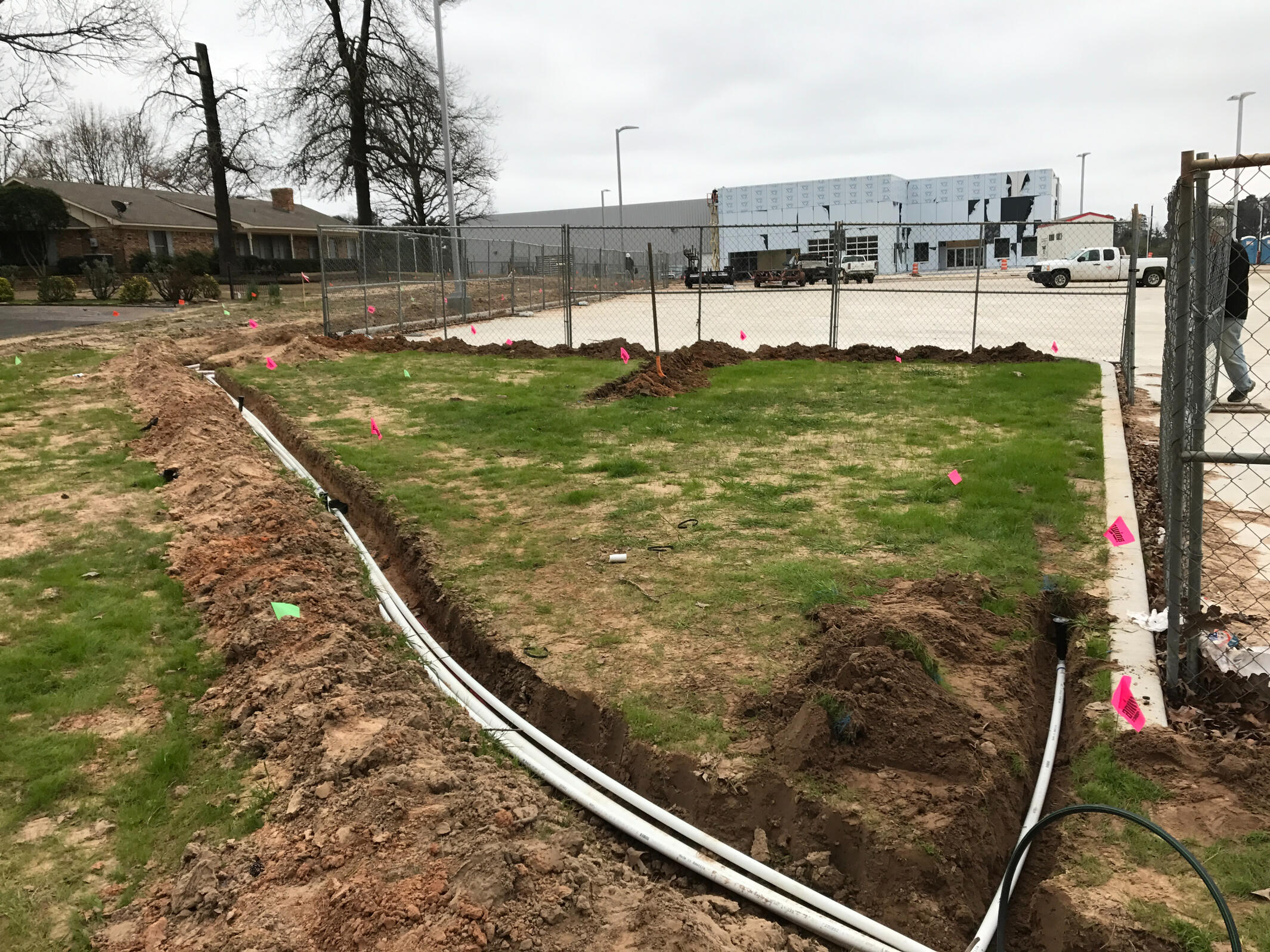 Commercial multi-line PVC irrigation trench installation in Longview, Texas. Advanced irrigation system construction for large East Texas properties.